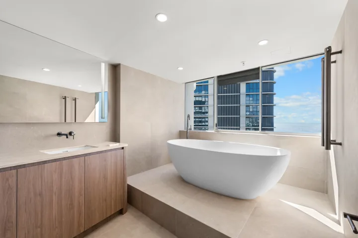 Main Beach bathroom with freestanding bath and curved vanity